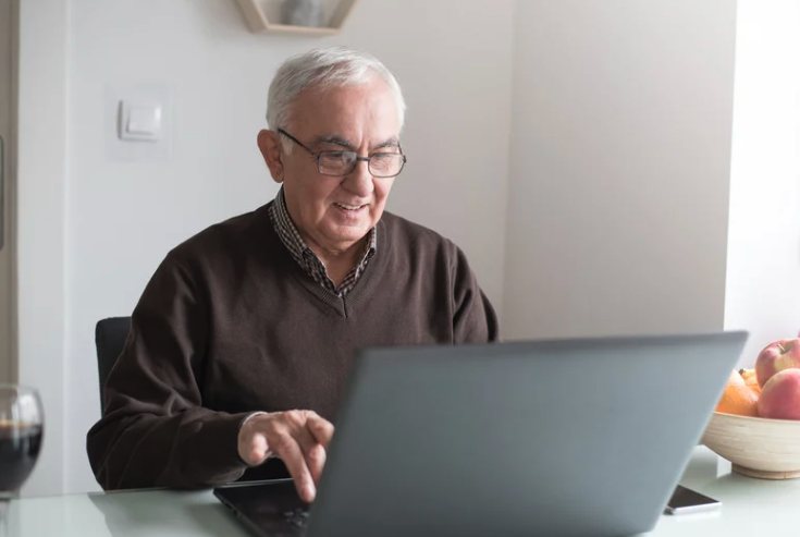 Older adult using a laptop